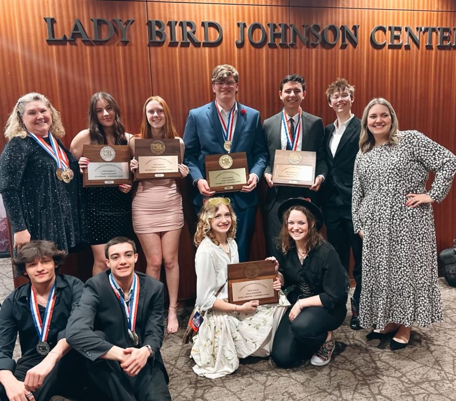 UIL film coach Stacy Short (left), assistant coach Caroline Robertson (right), and the five film crews show off their hardware at the LBJ Auditorium State Film Festival in Austin, Texas on February 22, 2023. Pictured from left to right (back) Short, Ashley Henderson, Rylie Halk, Sam Gassaway, Collin Norvell. Jack Myers, Robertson; front - Nicholas West, Garrett Neff, Grace May, and Molly Hartjen.