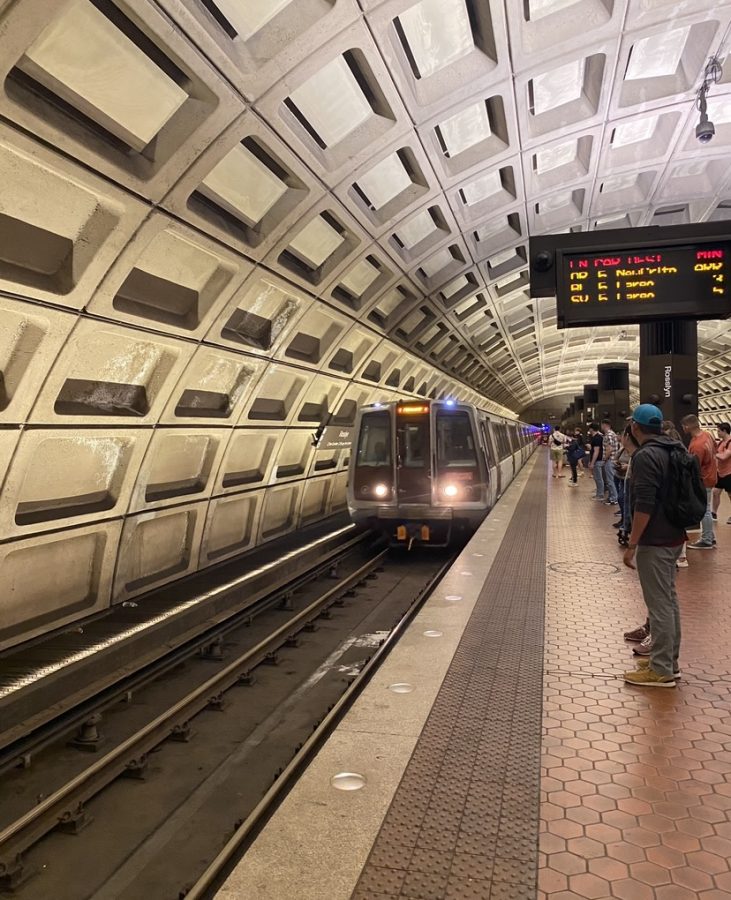 Passengers stand and wait as the DC Metro Blue Line train zips into the Roslyn Station. Taken on May 29, 2023.