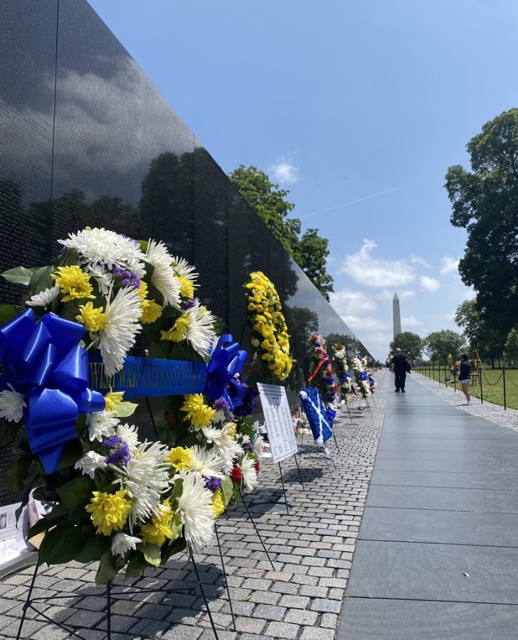 The Vietnam War Memorial bares wreaths with the Washington Monument looming in the distance. Taken on May 30, 2023.