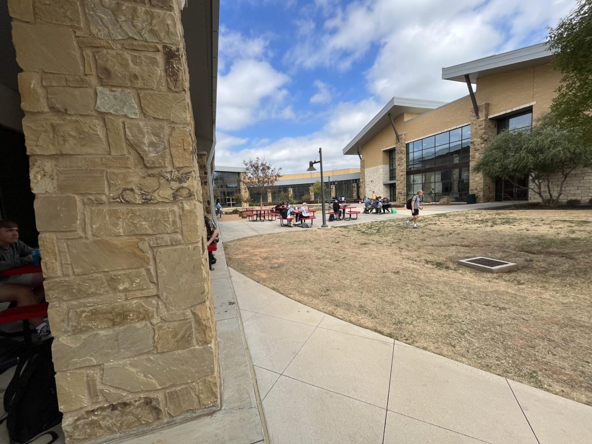 This is the courtyard during mega lunch. There are some kids sitting here eating and hanging out.