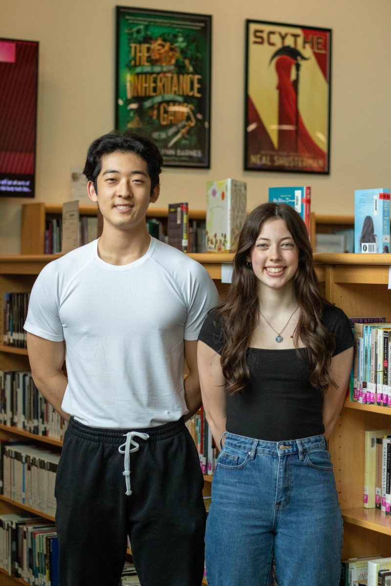 Noah Cha (left), and Caroline Deffenbaugh (right), stand for their National Merit Scholars photo.