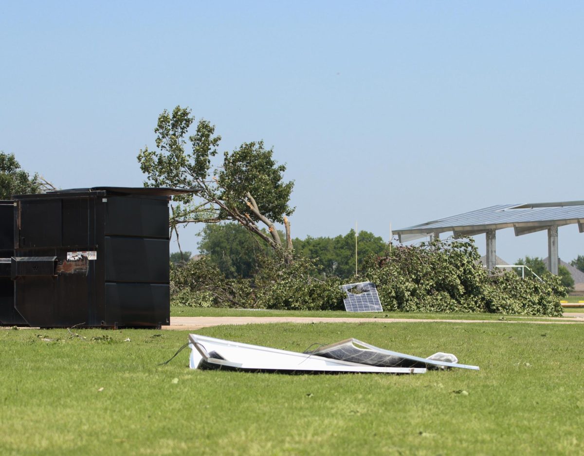 Solar panels are thrown from the roof of Pilot Point High School, and a tree is destroyed after a tornado hits. Taken May 26, 2024. 