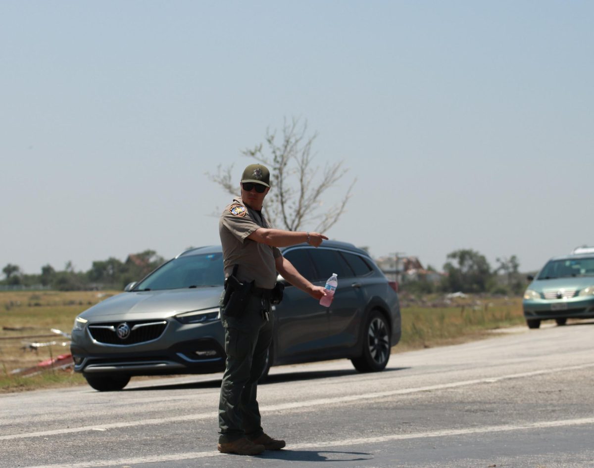 A Cooke County Sheriff directs traffic after a bridge is damaged from a tornado. Taken May 26, 2024. 