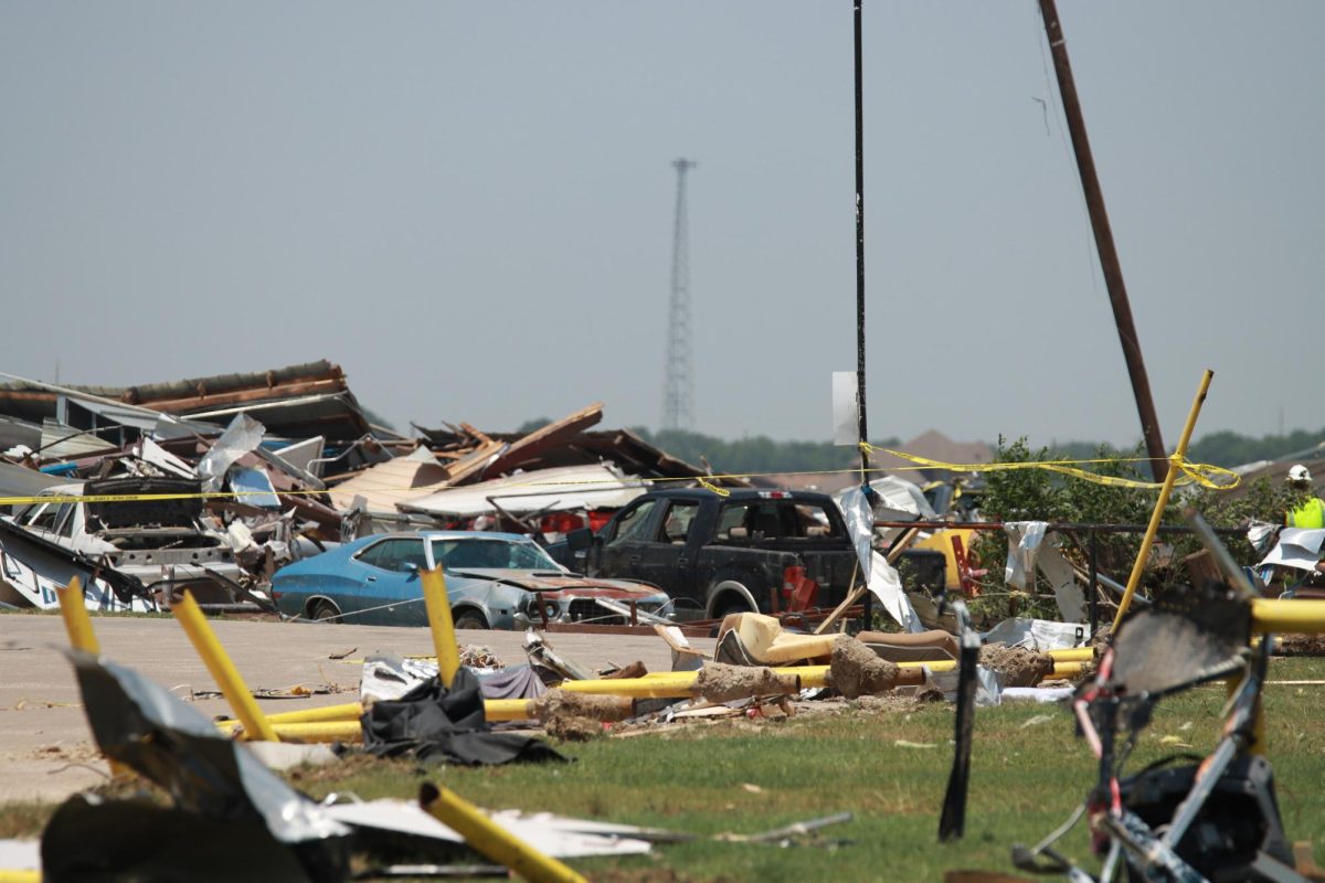 Cars sit under debris after a tornado hits. Taken May 26, 2024. 