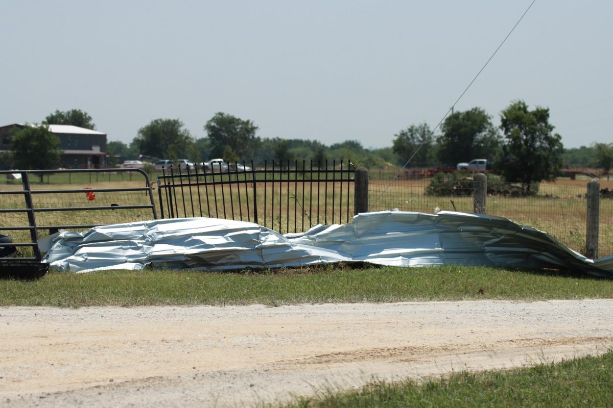 A piece of sheet metal debris is throw against a fence along Interstate 35. Taken May 26, 2024. 